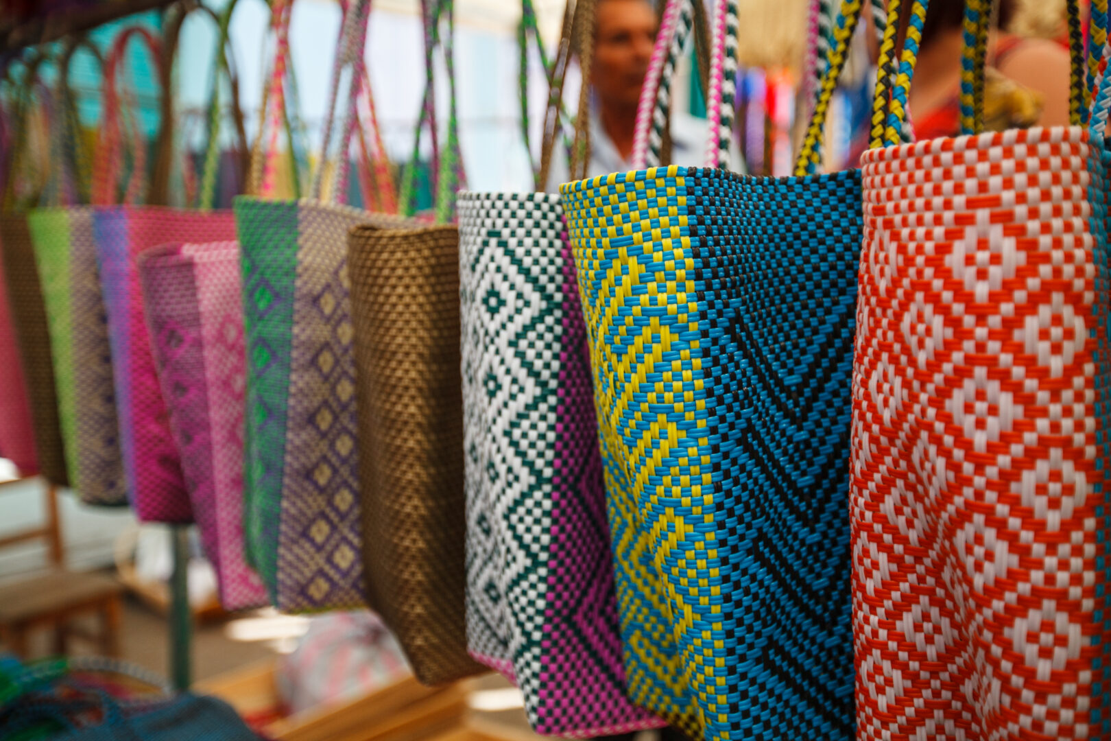 Beautiful vibrant handmade bags in a store Jute bag